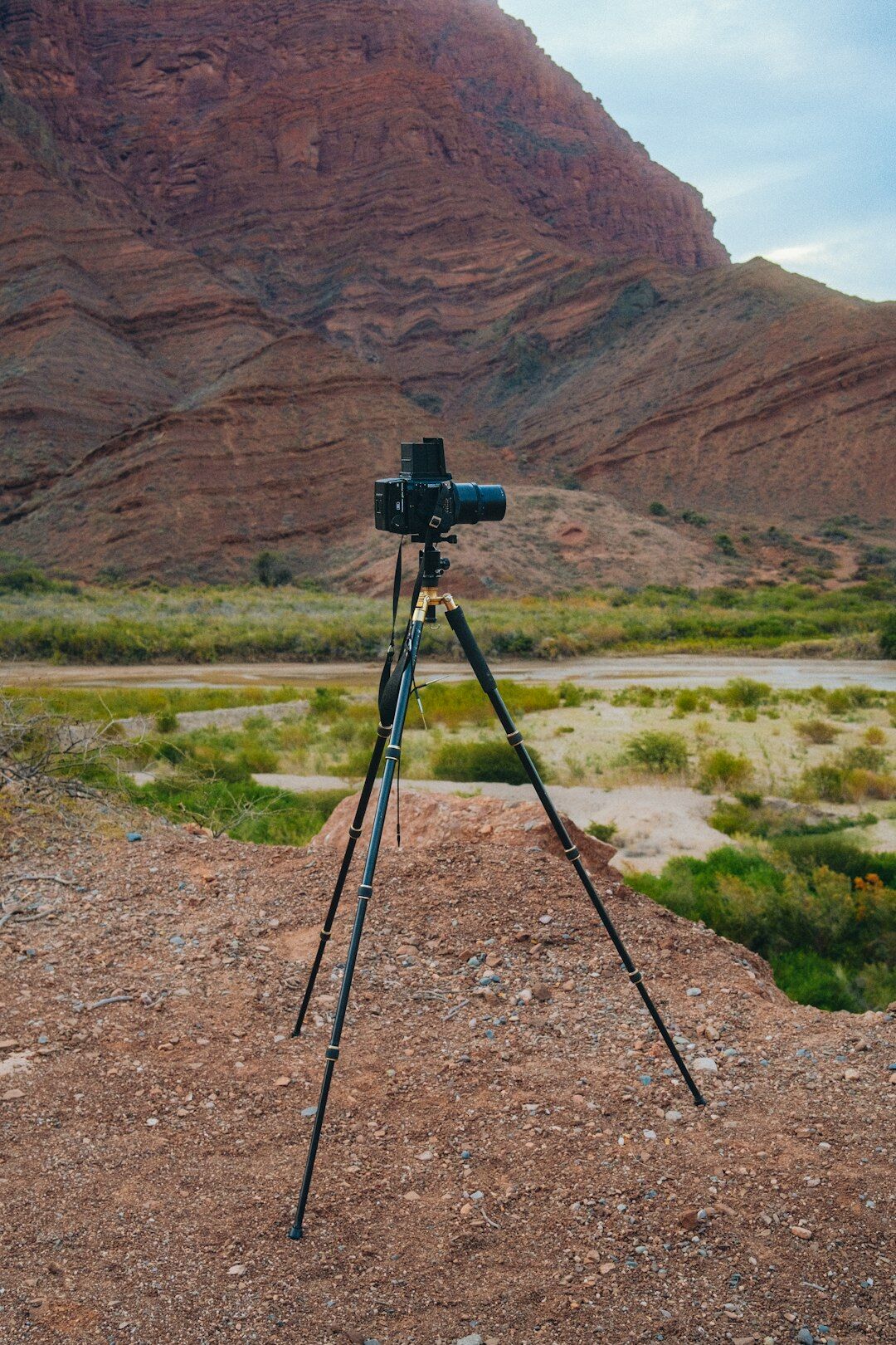 Camera on a tripod filming a mountain landscape