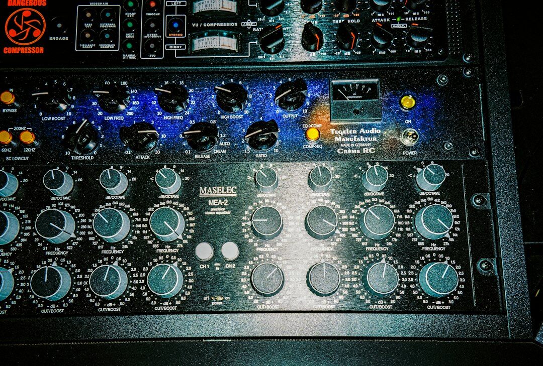 Audio mixing console with faders and a microphone